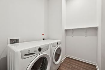 A white washing machine and dryer in a laundry room.